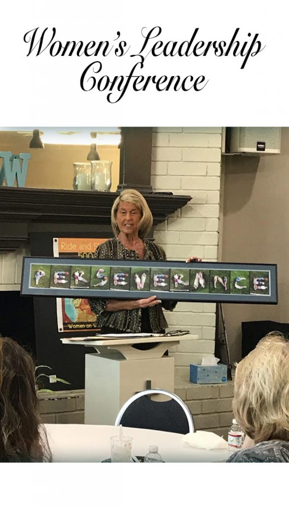 Anastasia holding a sign that says perseverance at the Women's Leadership Conference. Click to learn more.