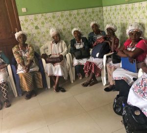 Class of Congolese teen mothers sitting in classroom.