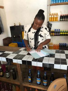 Congolese woman inside her verage bar at the counter.