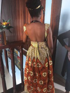Student modeling a beautiful dress made in tailoring classes (back view).